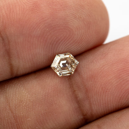 Hand scale view of the 0.68 ct Old Mine-style champagne diamond