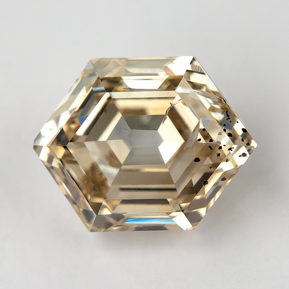 Close-up of the hexagonal step-cut diamond showing natural inclusions