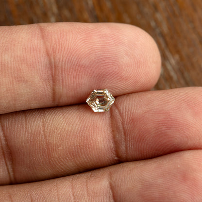 Wide hand-scale view of the 0.68 ct natural champagne diamond