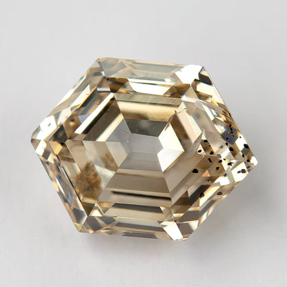 Close face-up view of the champagne hexagon diamond and open culet