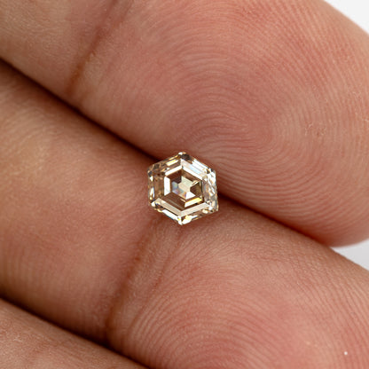 Old Mine-style hexagon diamond shown on a finger for size reference