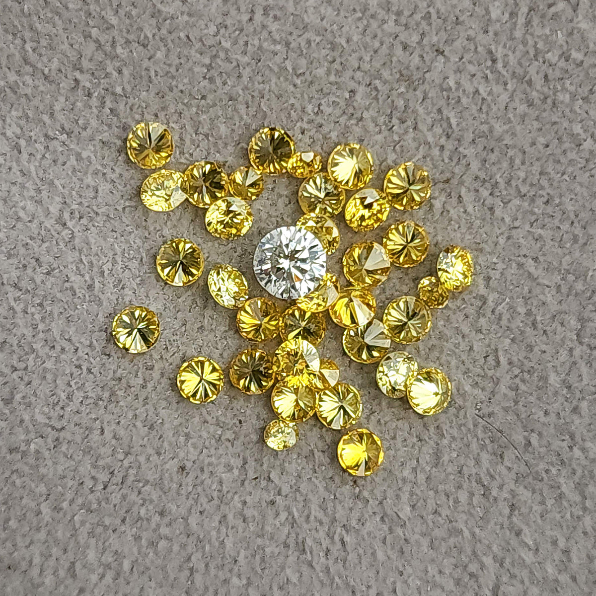 Yellow diamond cluster on grey with a white comparison diamond, not included.