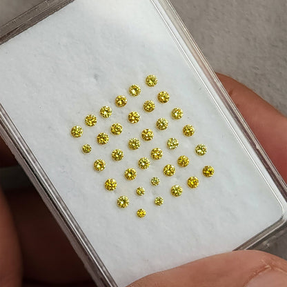 White display pad of yellow diamonds tilted in a hand.