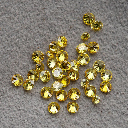 Close yellow diamond cluster on grey with mixed face-up and tilted views and an excluded white comparison.