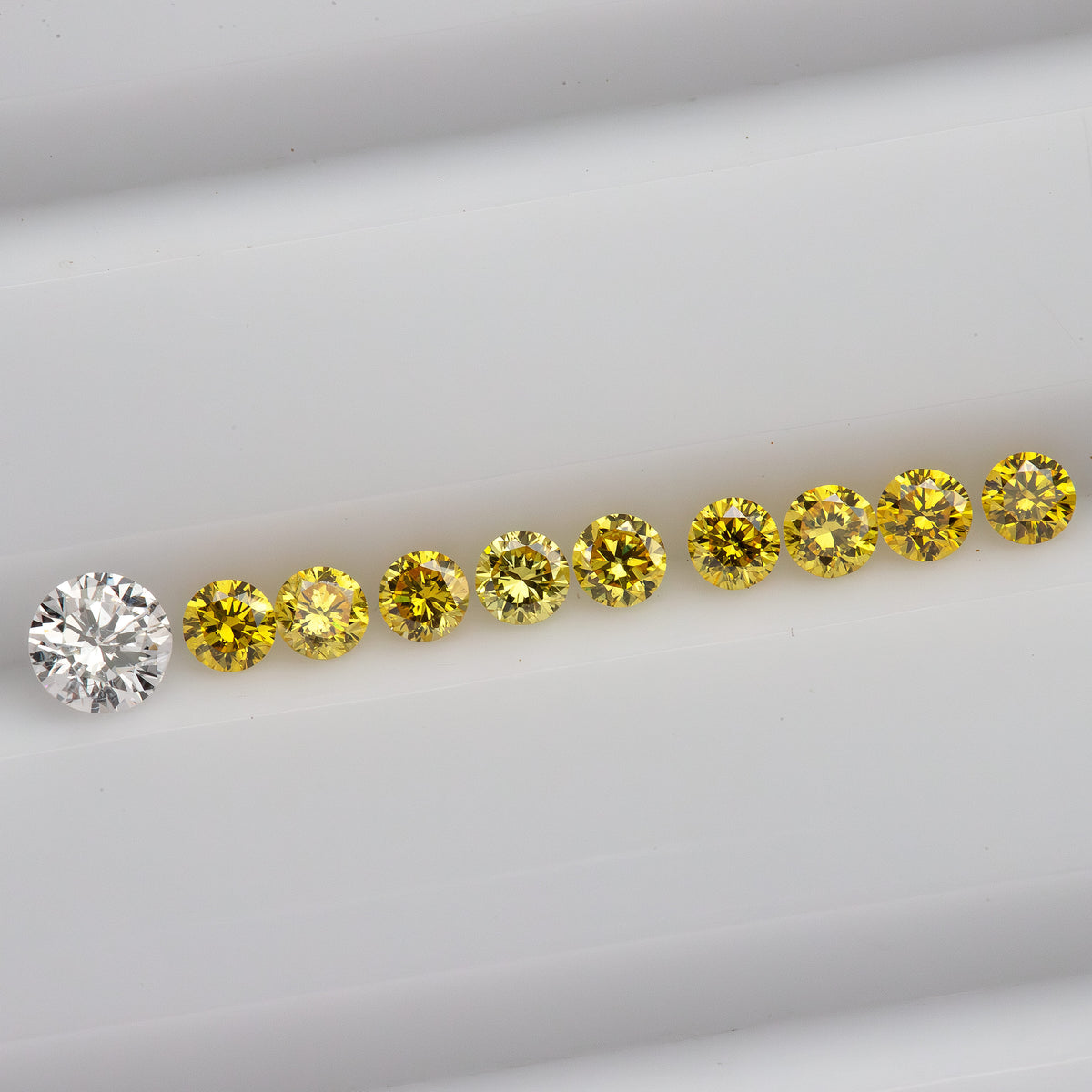 Horizontal face-up yellow diamond line on white beside an excluded white comparison diamond.