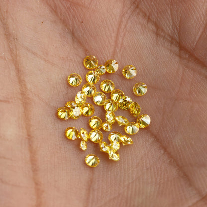 Wider palm view of yellow diamond cluster and an excluded white comparison diamond.