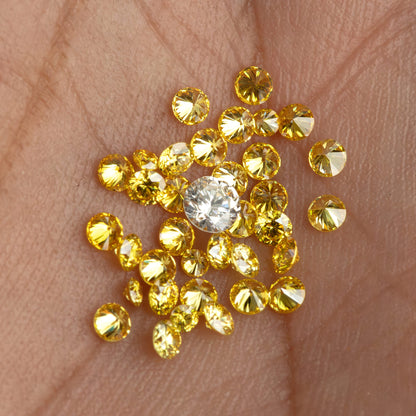 Alternate hand-scale view of yellow diamonds with an excluded white comparison diamond.