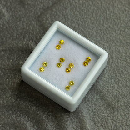 Six yellow diamond pairs in a diagonally placed tray on a grey textured background.