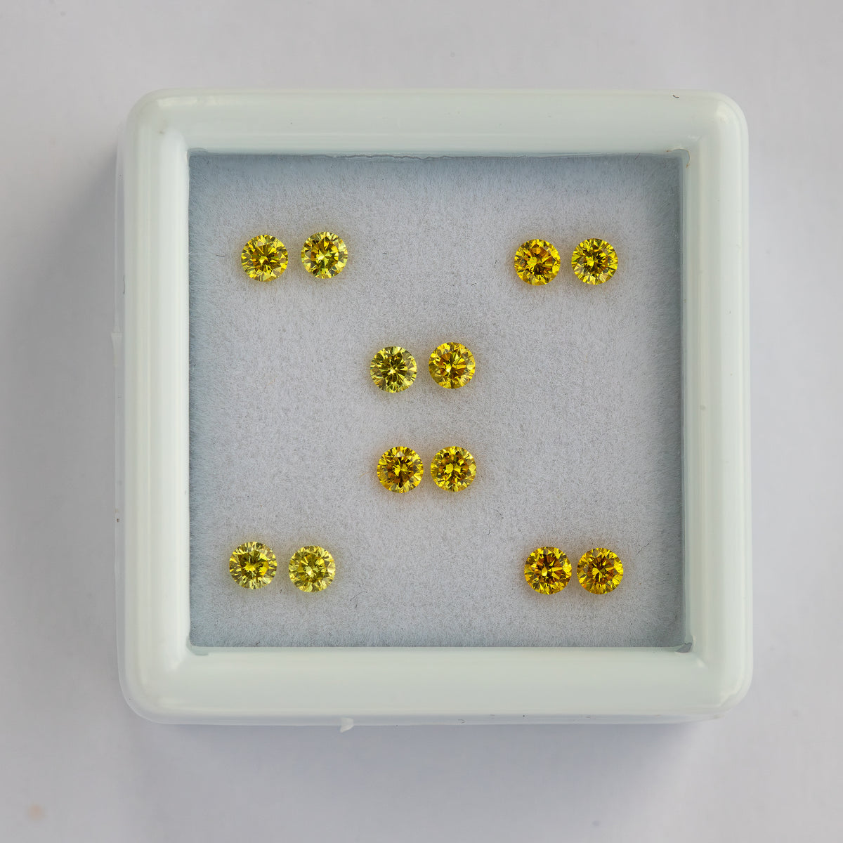 Overhead white-tray view of the six yellow diamond pairs.