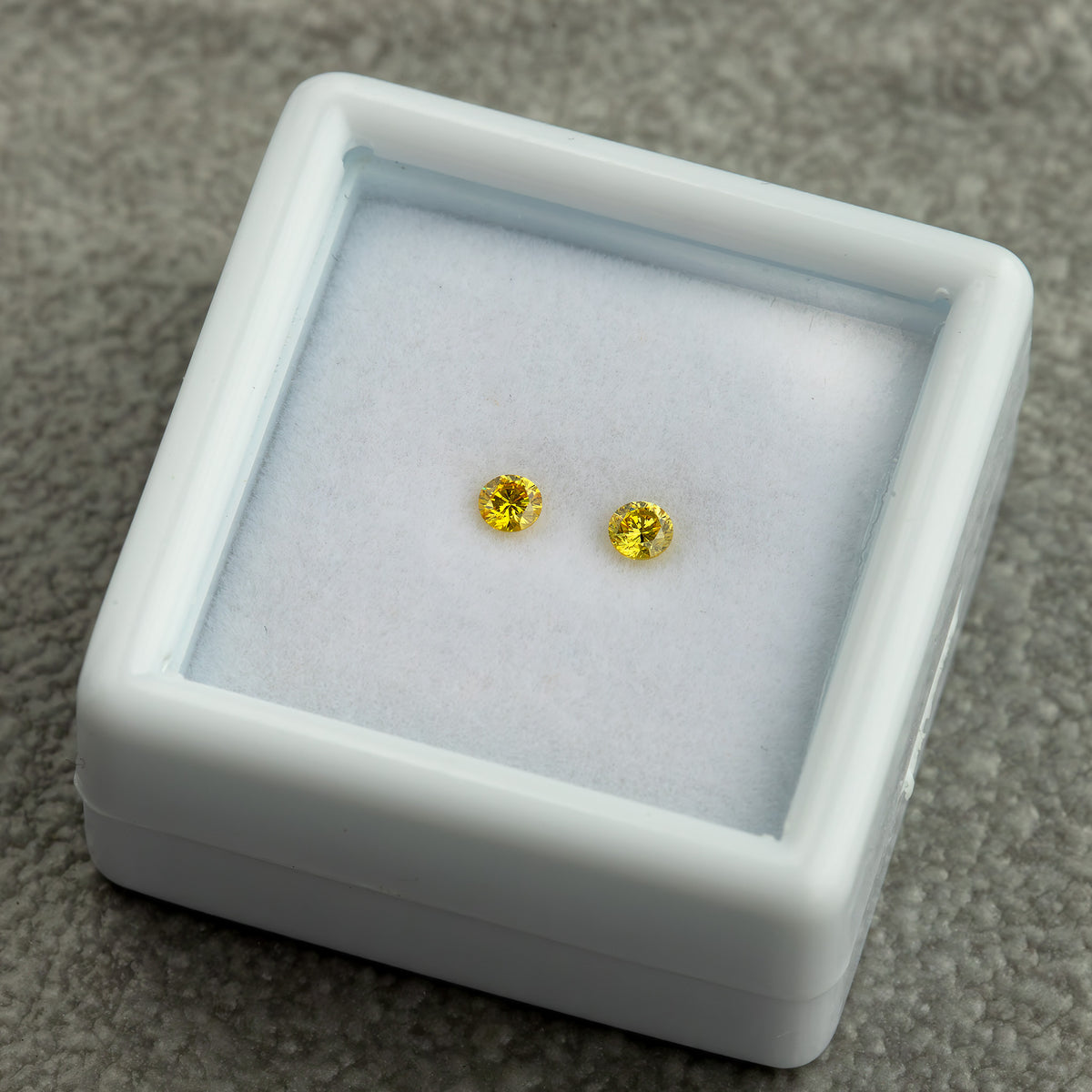 Angled presentation-box view of the exact canary yellow diamond pair