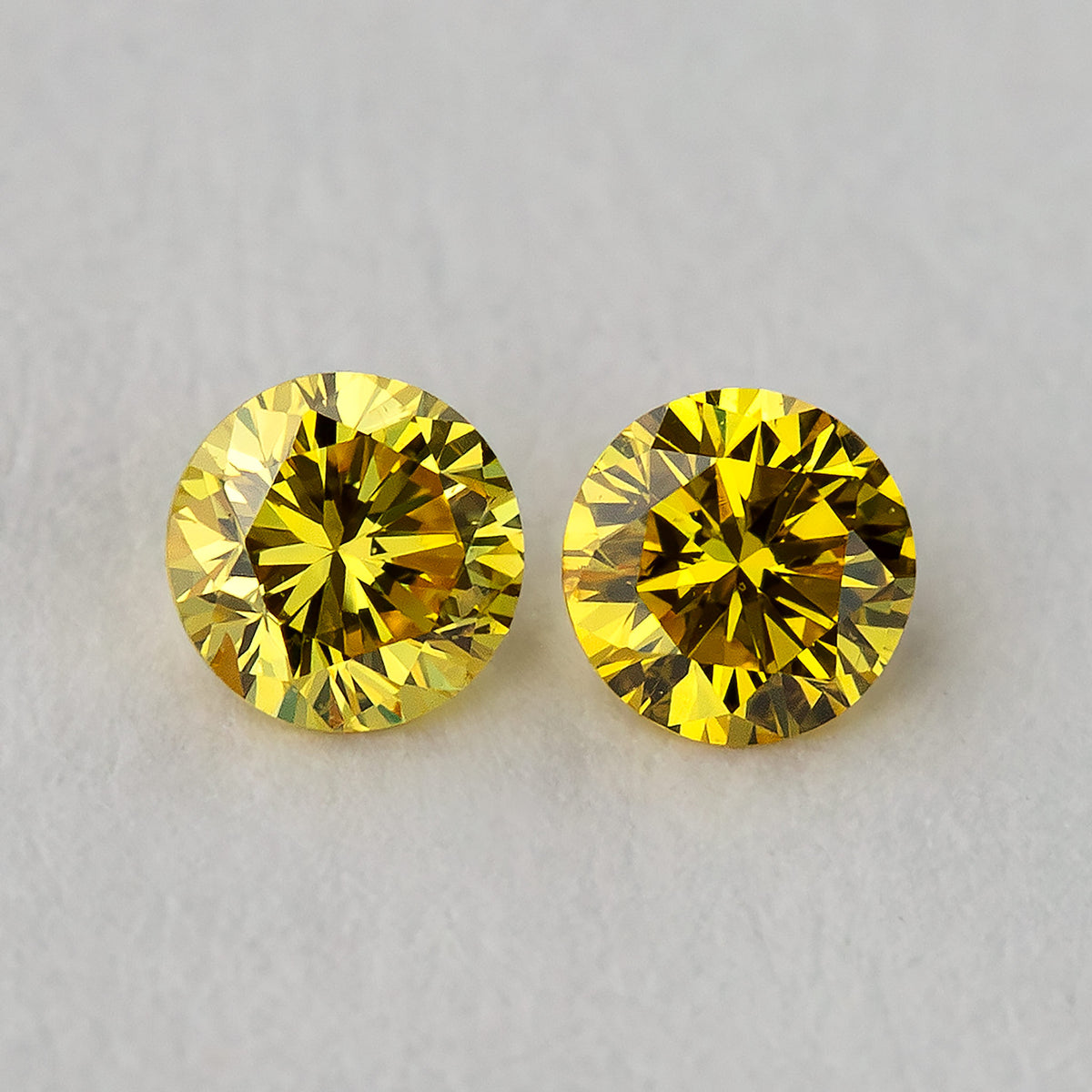 Macro close-up of the exact matched canary yellow round brilliant diamond pair