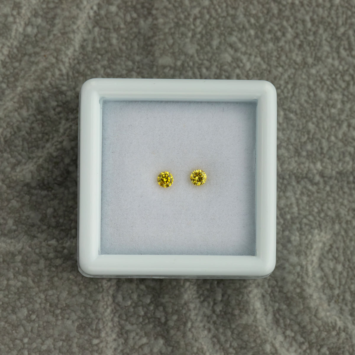 Overhead view of the exact natural yellow diamond pair