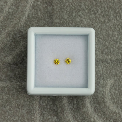 Overhead view of the exact natural yellow diamond pair
