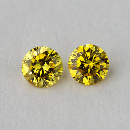 Face-up view of two matched 2.40 mm round brilliant yellow diamonds