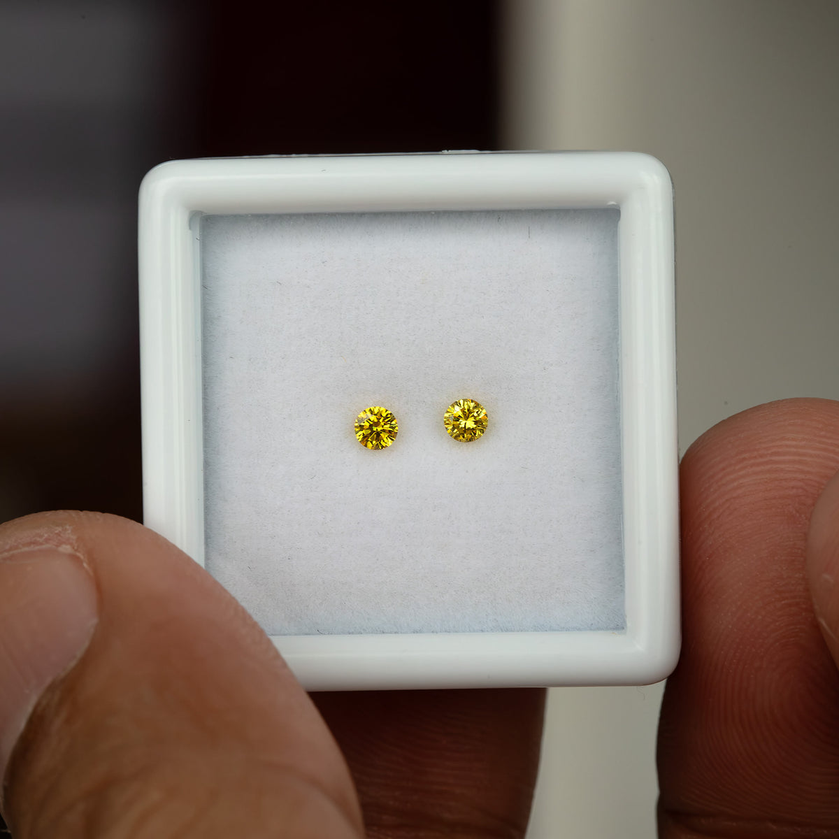 Exact 2.40 mm yellow diamond pair shown against a hand for scale