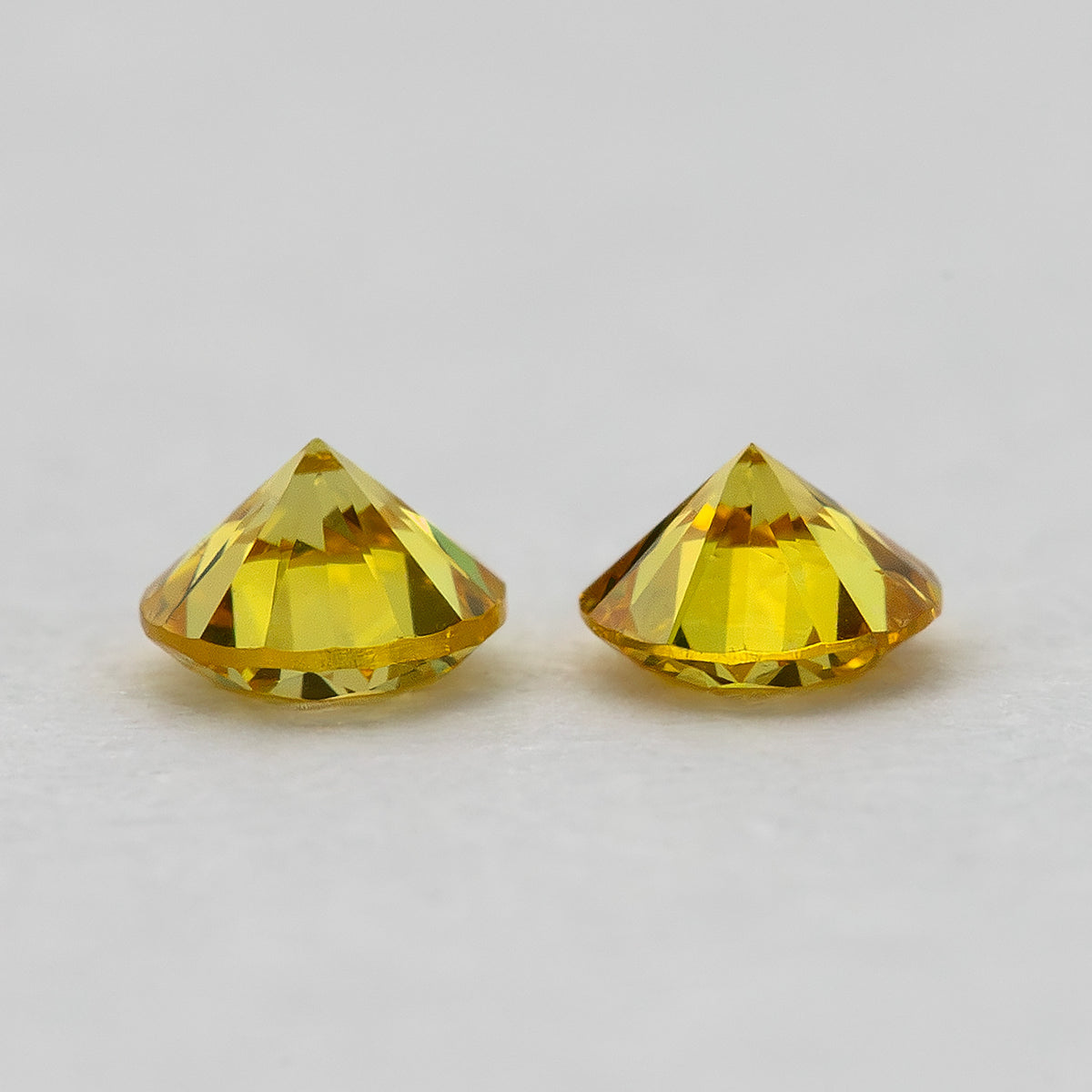 Side-profile view showing the matched yellow diamonds' depth and faceting