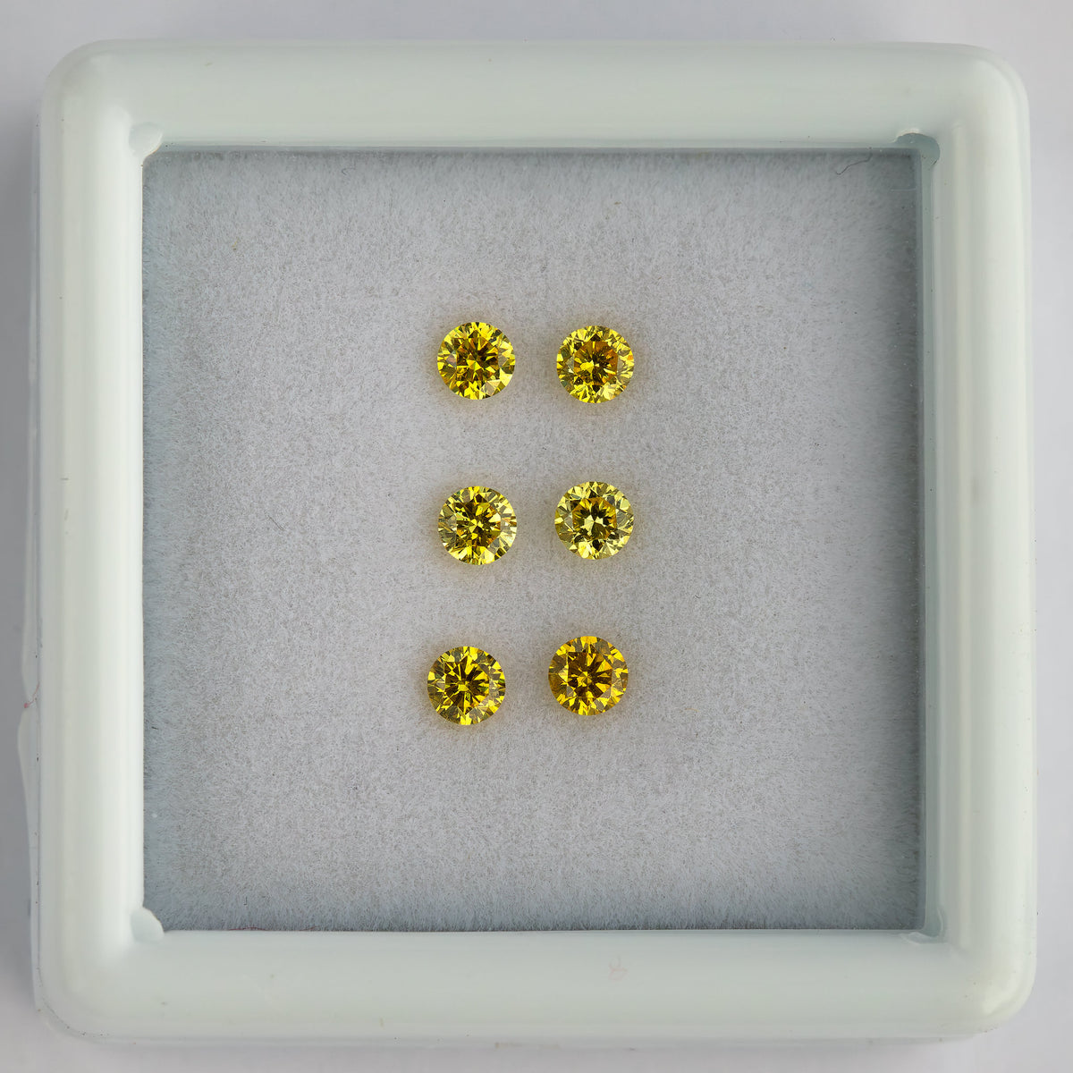 Centered white tray displaying three horizontal rows of yellow diamond pairs.