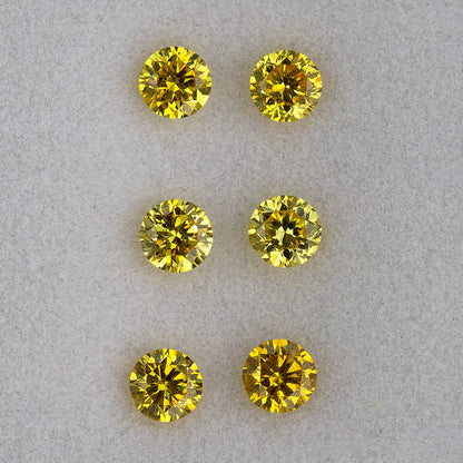 Macro face-up view of three pairs showing their round outlines and facets.