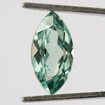 Face-up view of a mint-green marquise lab-grown sapphire held vertically between tweezers.

Video of a mint-green marquise lab-grown sapphire shown against fingers.
