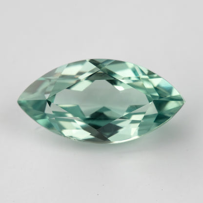 Horizontal face-up view of a mint-green marquise lab-grown sapphire, showing a pattern of light and dark facets.