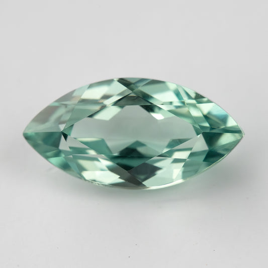 Horizontal face-up view of a mint-green marquise lab-grown sapphire, showing a pattern of light and dark facets.