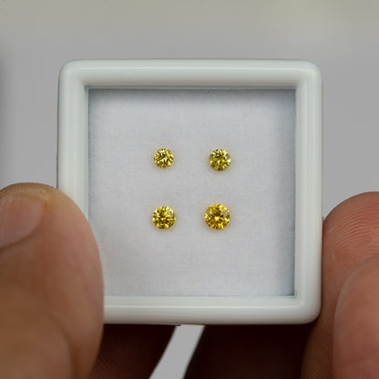 Hand-held white tray with four yellow diamonds, showing their differing diameters.
