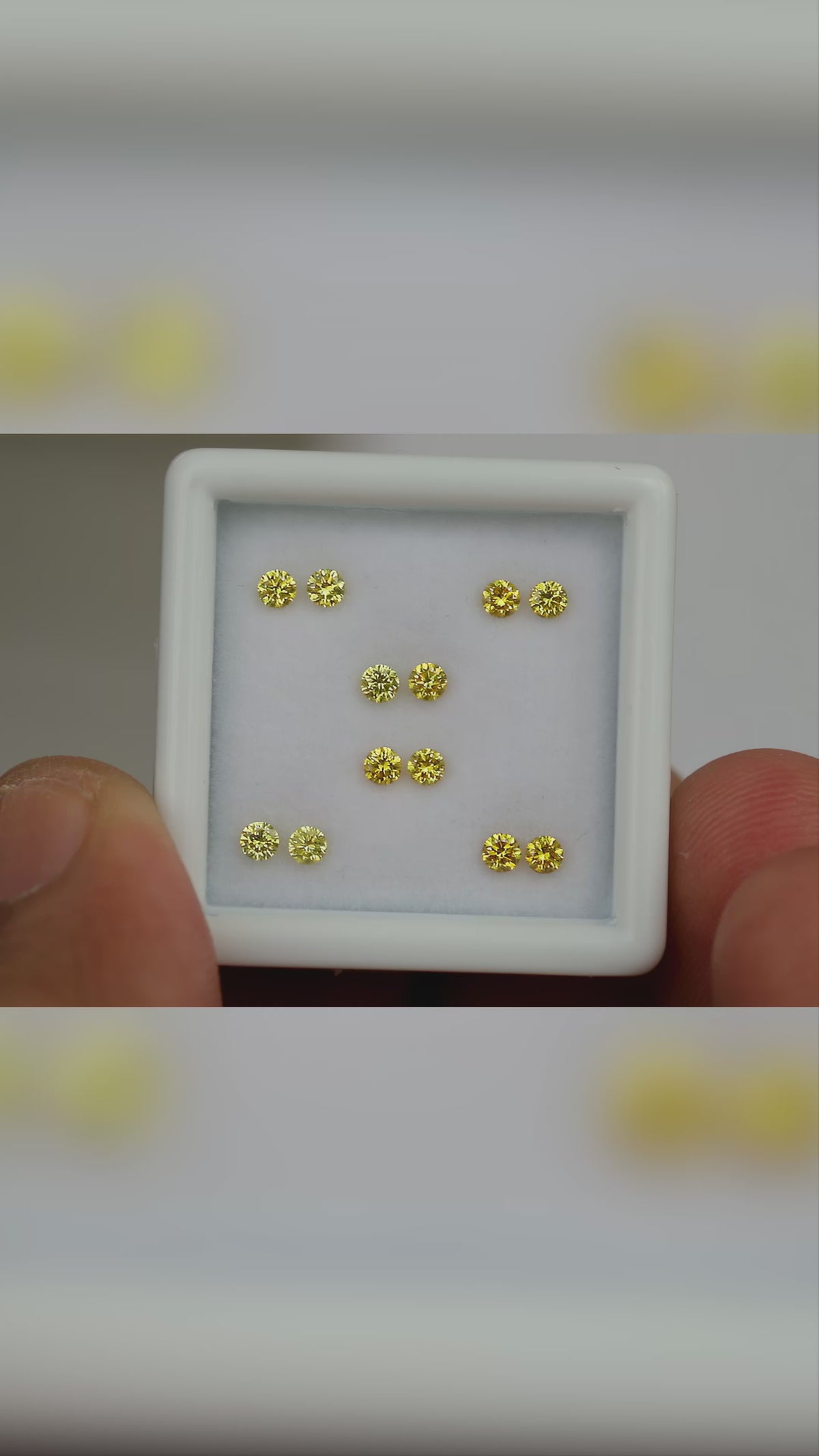 Natural canary yellow diamonds shown in motion; purchase contains only the selected pair or individual diamond.