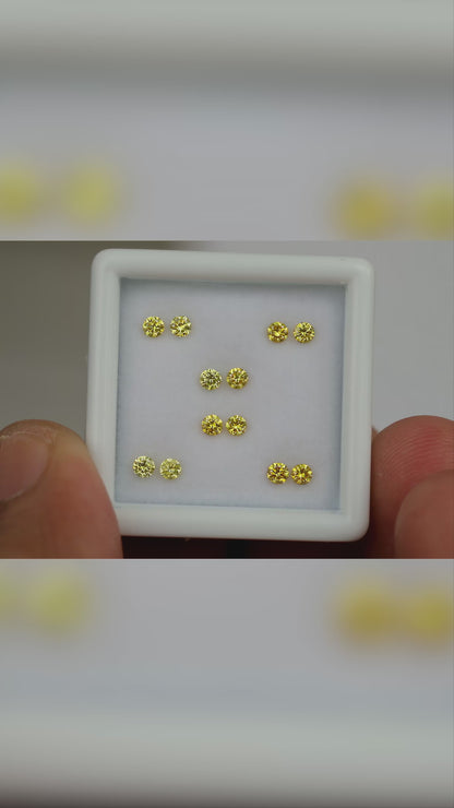 Natural canary yellow diamonds shown in motion; purchase contains only the selected pair or individual diamond.