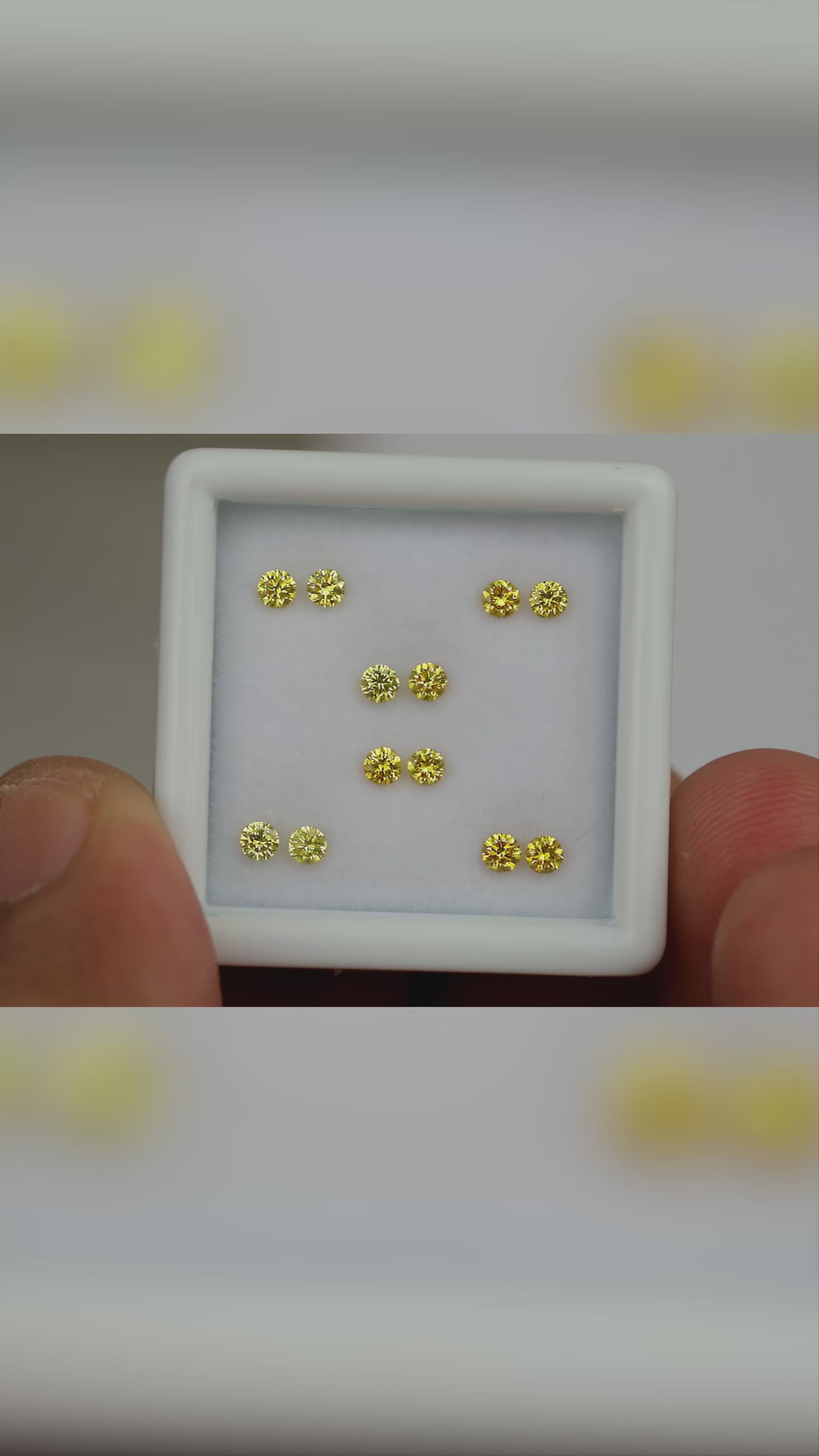 Natural canary yellow diamonds shown in motion; purchase contains only the selected pair or individual diamond.