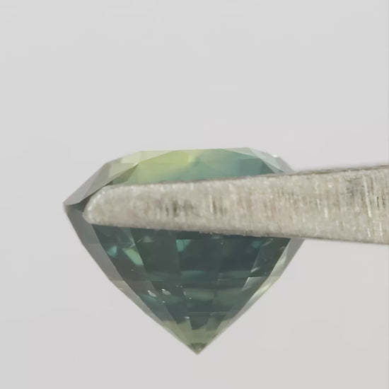 Video showing the teal blue green round sapphire through changing viewing angles.