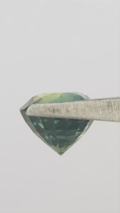 Video showing the teal blue green round sapphire through changing viewing angles.