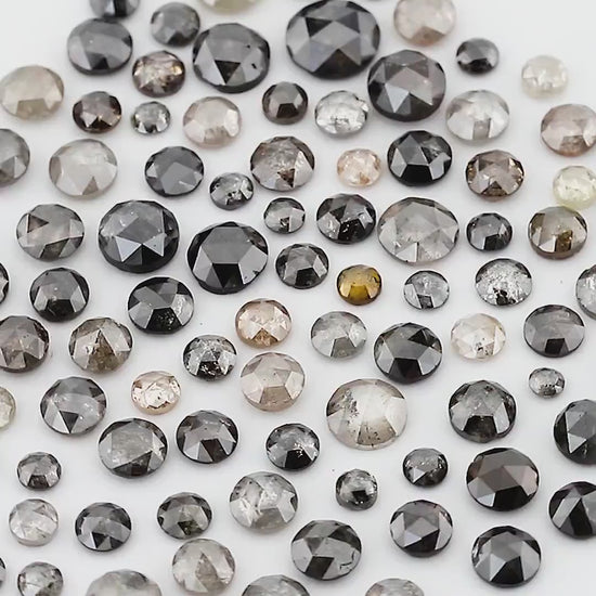 Moving views of the mixed grey and black rose-cut source parcel; random scoop contents vary.