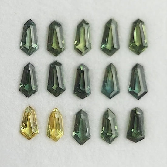 Green and yellow-green sapphire selection shown in rotating views of the fifteen-stone tray; sold one selected stone at a time.