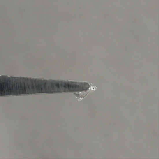 Representative marquise diamond shown from angled and pavilion views in tweezers, then face-up on fingertips for scale; sold one diamond per selected clarity option.