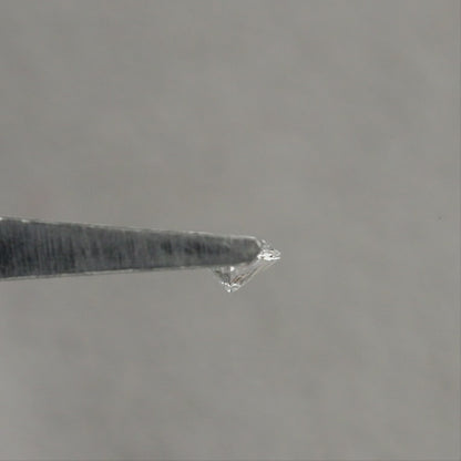 Representative marquise diamond shown from angled and pavilion views in tweezers, then face-up on fingertips for scale; sold one diamond per selected clarity option.