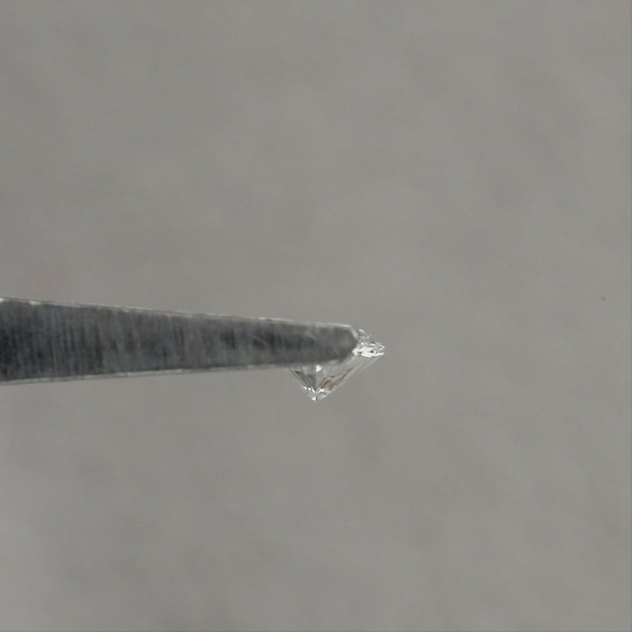 Representative marquise diamond shown from angled and pavilion views in tweezers, then face-up on fingertips for scale; sold one diamond per selected clarity option.