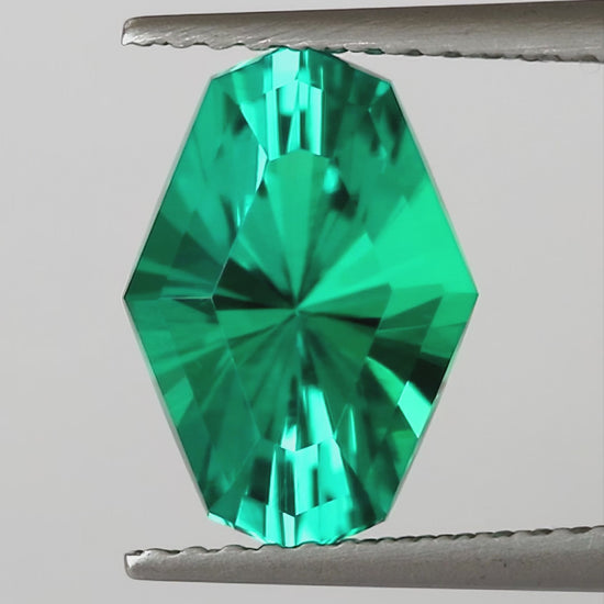Natural-light finished video of the representative BLS200 green lab-grown emerald, showing face-up, reverse and finger scale views.