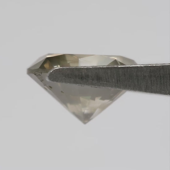 KL444 natural diamond turning in tweezers, showing face-up reflections, side and pavilion views, followed by views on the hand for scale.