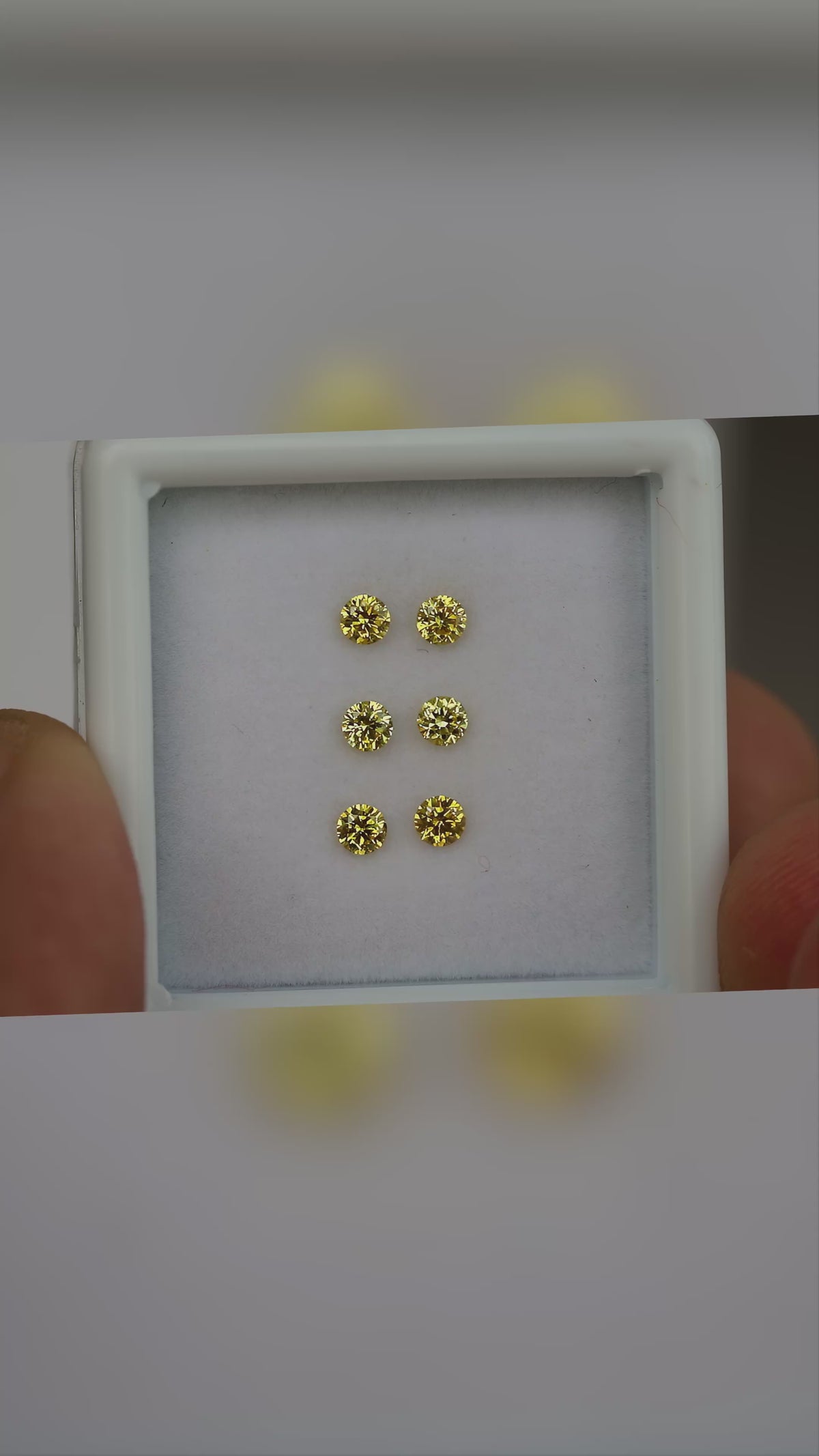 Natural canary yellow diamonds shown in motion; purchase contains only the selected pair or individual diamond.