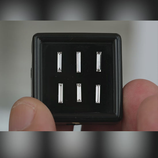 Six individually selectable long baguette diamonds in a handheld black box, followed by a close face-up view of their unchanged two-row selection layout.