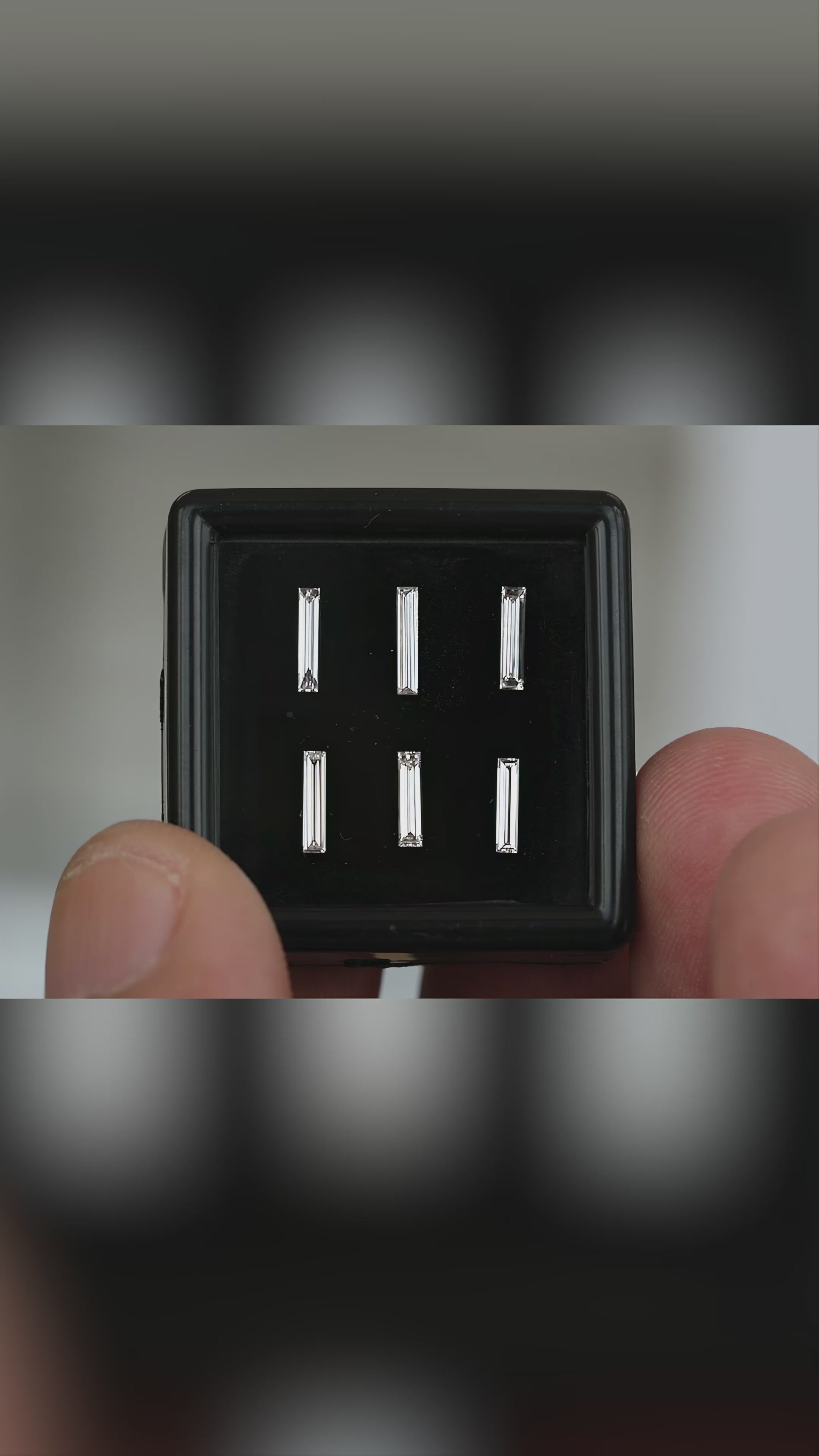 Six individually selectable long baguette diamonds in a handheld black box, followed by a close face-up view of their unchanged two-row selection layout.
