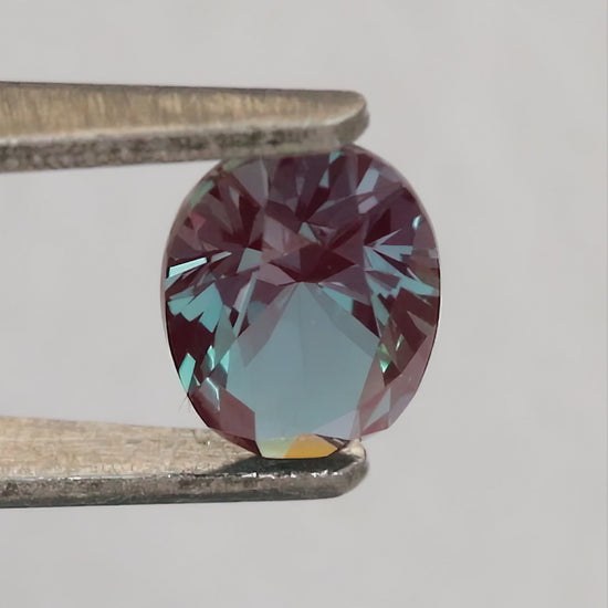 Merchant-finished natural-light video of the oval lab-grown alexandrite design, including crown, back and fingertip-scale views.
