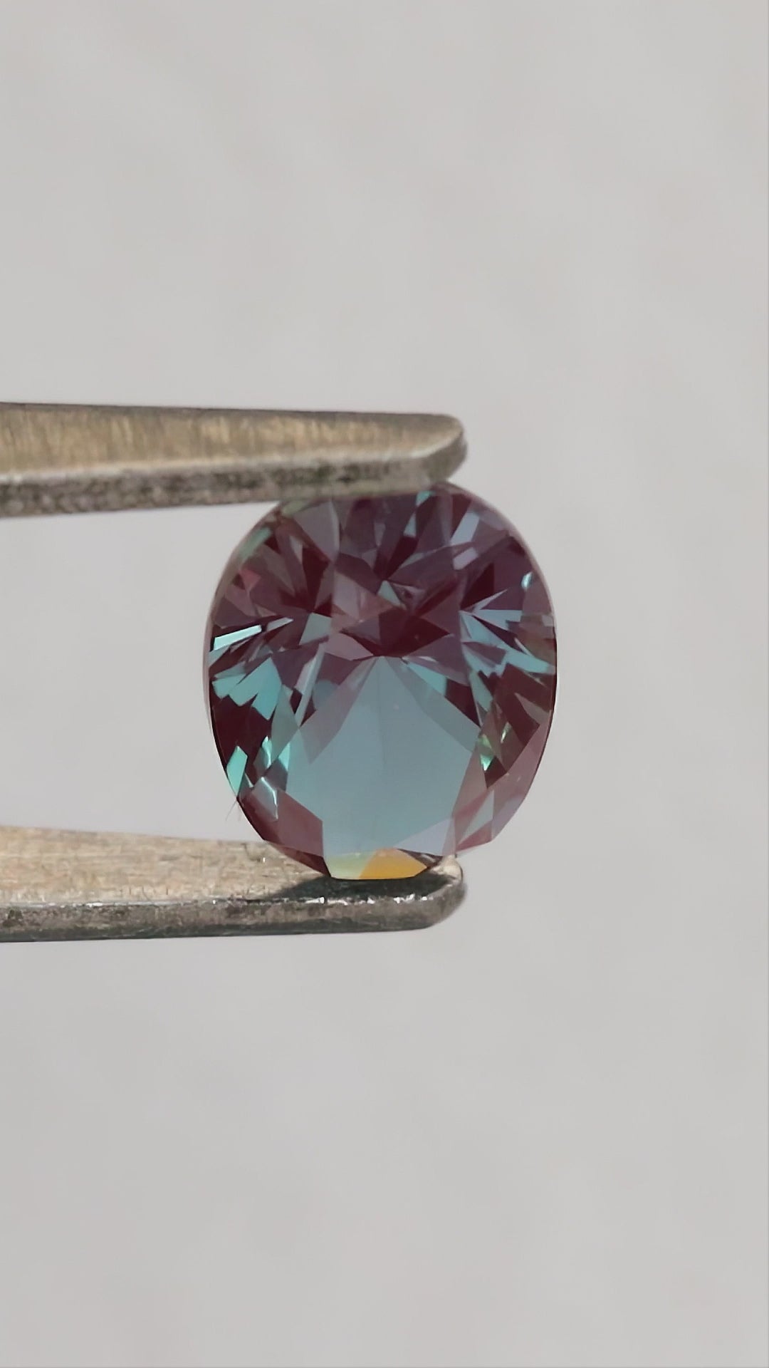 Merchant-finished natural-light video of the oval lab-grown alexandrite design, including crown, back and fingertip-scale views.