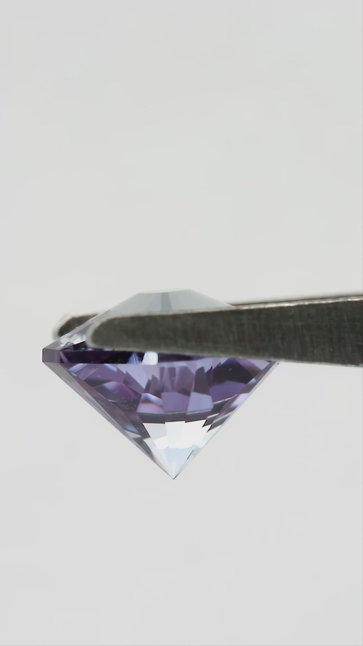 Hanami-cut lab-grown sapphire shown from pavilion and profile angles, followed by finger-held face-up views for scale.