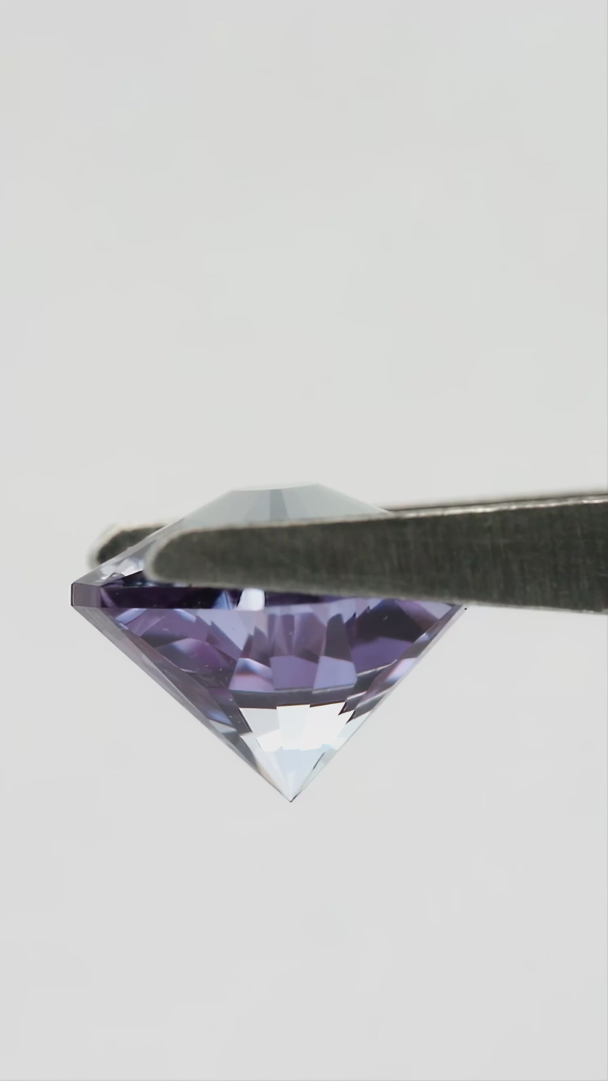 Hanami-cut lab-grown sapphire shown from pavilion and profile angles, followed by finger-held face-up views for scale.