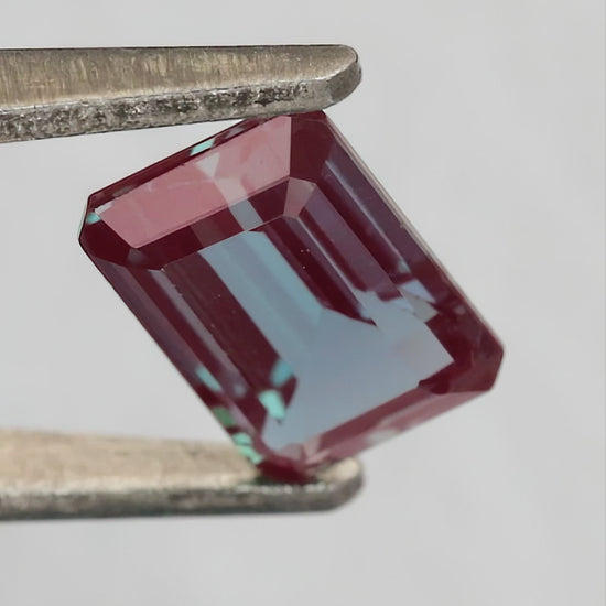Merchant-finished natural-light video of the emerald cut lab-grown alexandrite design, including crown, back and fingertip-scale views.