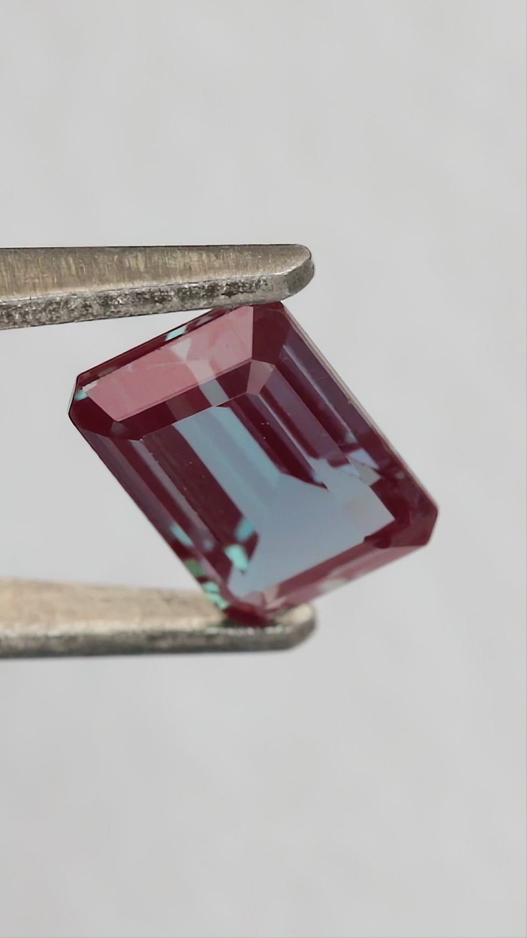 Merchant-finished natural-light video of the emerald cut lab-grown alexandrite design, including crown, back and fingertip-scale views.