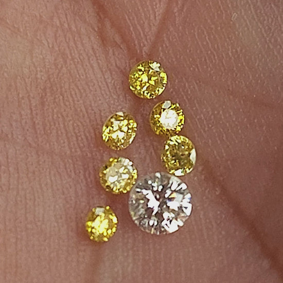 Six natural canary yellow diamonds in motion; the white comparison diamond is excluded.