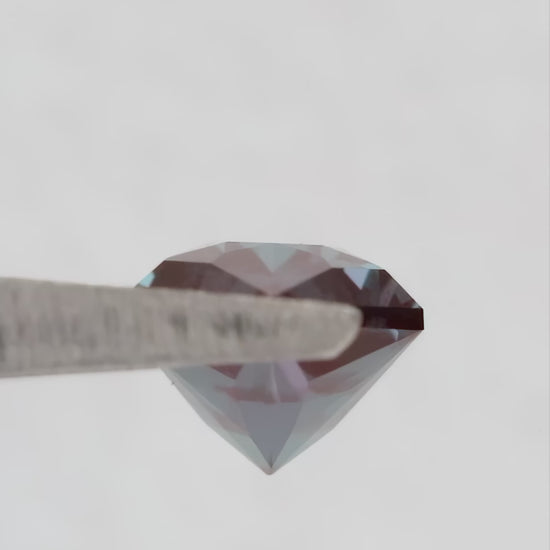 Video of BLS112 in tweezers, showing its facets and color response as the viewing angle changes.