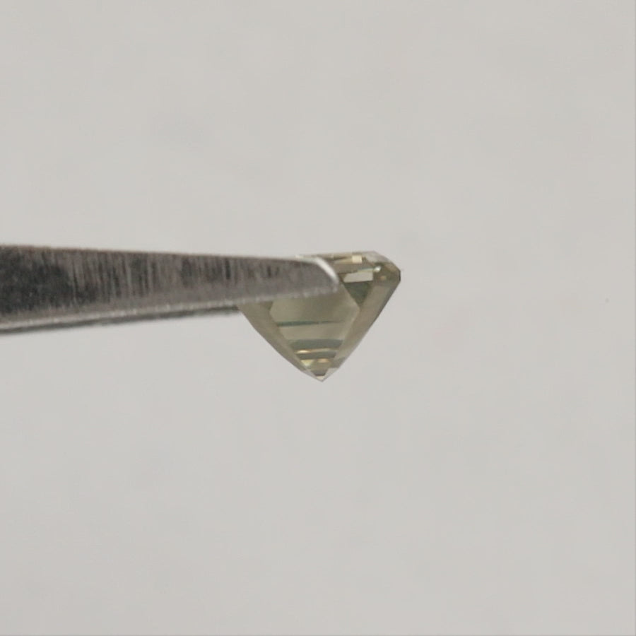 Emerald-cut diamond rotating in tweezers from crown to reverse views, followed by horizontal fingertip views showing its scale.